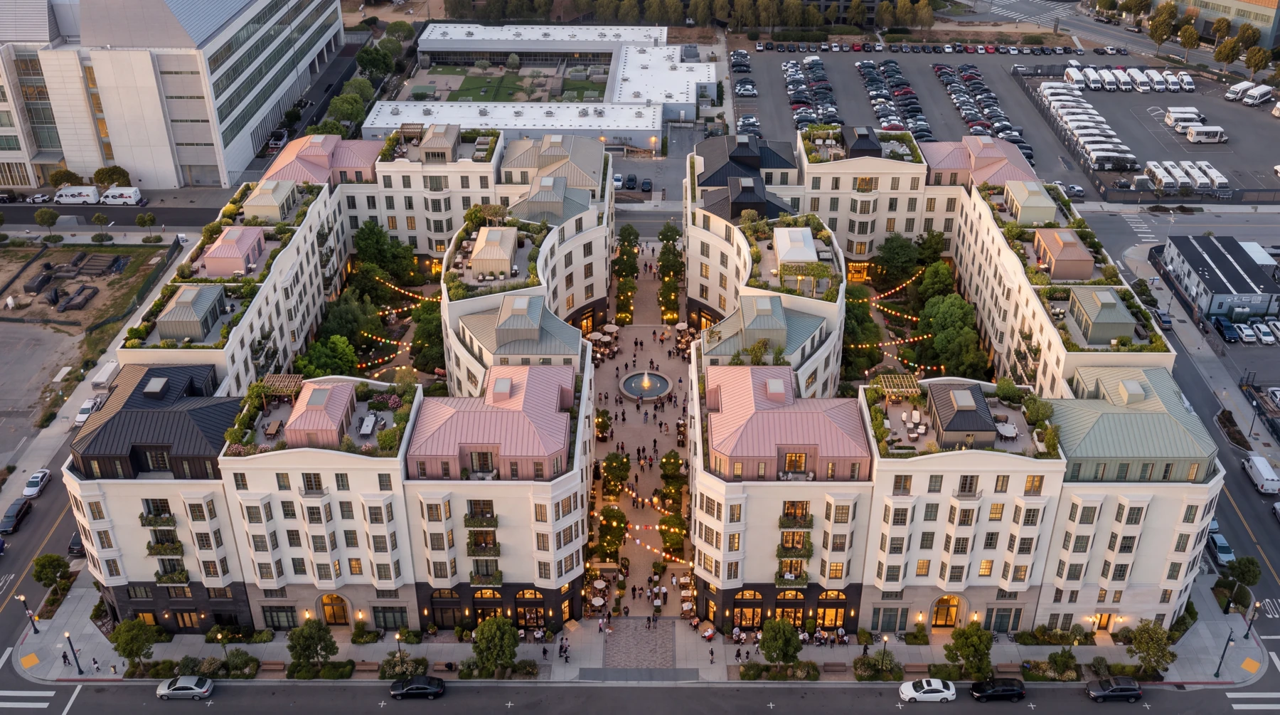 Mission Bay concept at dusk, with two planted courtyard blocks, a central fountain piazza, shops and rooftop terraces.